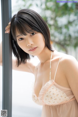 A woman in a white lingerie posing for the camera.