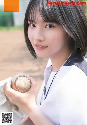 A woman in a school uniform posing for a picture.