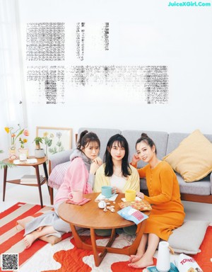 A group of young women hugging each other in a magazine.