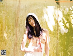 A woman laying on the ground with her hands on her head.