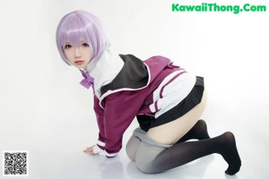 A woman in a school uniform is laying on the floor.