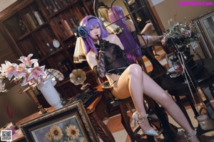 A woman with purple hair sitting on a chair.