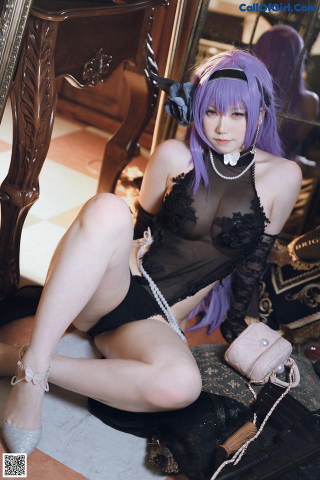 A woman with purple hair sitting on the floor.