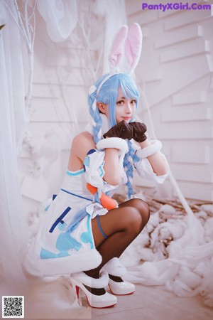 A woman dressed in a bunny costume posing for a picture.