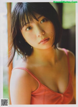 A woman in a school uniform is posing for a magazine.