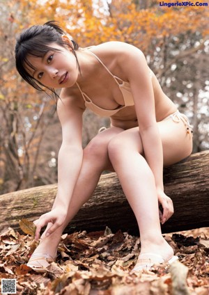 A young woman with black hair and a white shirt.