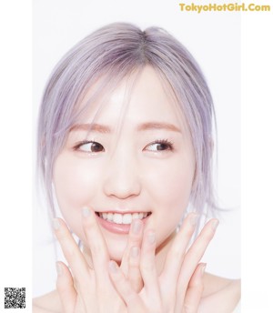 A woman with purple hair and a white background.