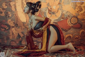 A woman in a belly dance costume is posing for a picture.