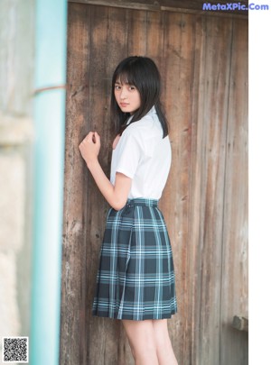 A woman with long black hair is posing for a picture.