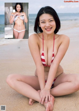 A woman in a white bikini sitting on a table.