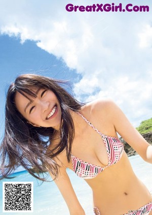 A woman in a pink bikini on the cover of a magazine.