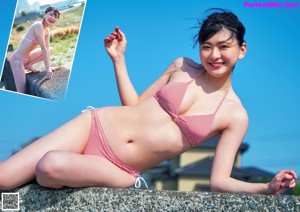 A woman in a black and white bathing suit posing for a picture.