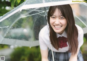 A woman in a school uniform is posing for a picture.