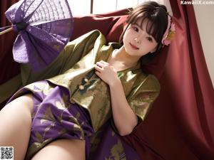 A woman in a kimono sitting on the ground next to a pool.