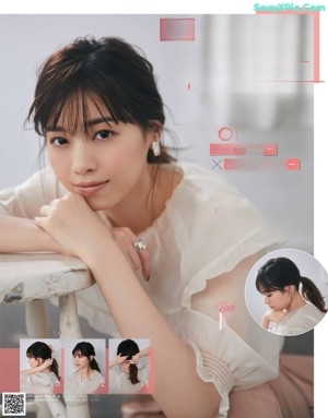 A woman in a white shirt holding a necklace and earrings.